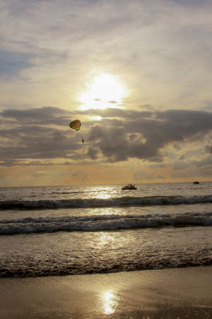 Parasailing during sunsetの写真素材