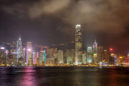 Skyline of Hong Kong  at Night with the colours reflecting off the harbour.の写真素材