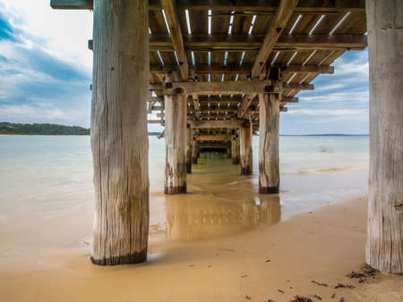 Under the fishing pier on the Beachの写真素材