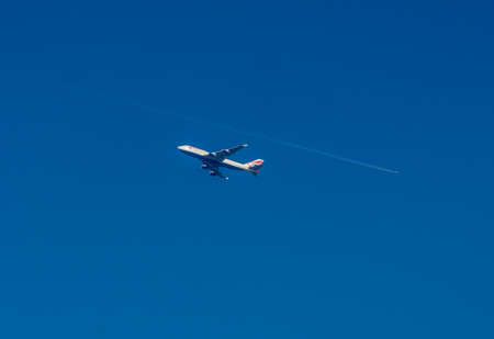 Boeing 747 Jumbo with a vapour trail of another plane above