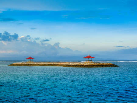 Balinese gazebo out on the open water during sunsetの写真素材