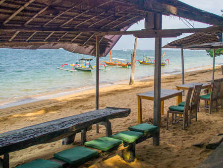 Tables and chairs for drinkning and eating on the beachの写真素材