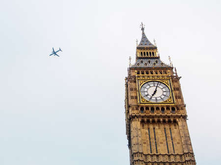 Big Ben clock tower and an airplaneの写真素材