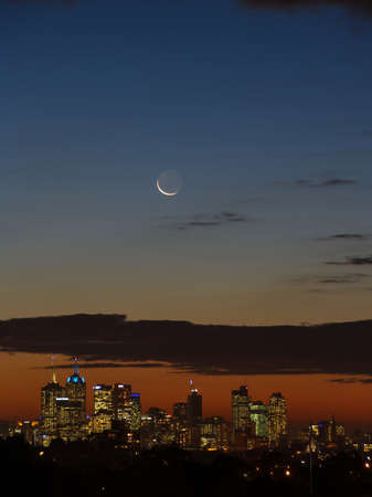 AUSTRALIA, MELBOURNE - MAY 30, 2014: Moon above the Melbourne City skyline just after sunsetのeditorial素材
