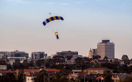 AUSTRALIA, MELBOURNE - January 02, 2015: Skydiver with colorful parachute decending to ground.のeditorial素材