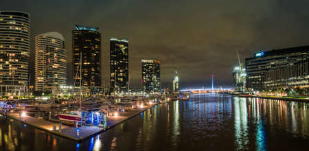 Buildings around the Dockland area of Melbourne illuminated at nightの写真素材