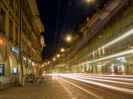 SWITZERLAND, BERN - MARCH 27, 2015: Tram going through shopping alley Kramgasse in Bern at night