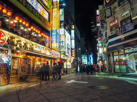 JAPAN, TOKYO - APRIL 19, 2019: Shinjuku nightlife with bright lights and endless crowds visiting the areas bars and restaurantsのeditorial素材