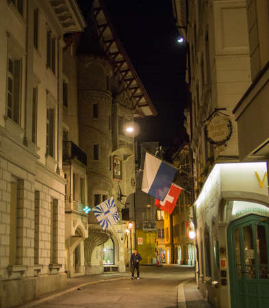Switzerland, Lucerne - March 24, 2015: A pedestrian walks along the old cobble stoned streets at night in the old town of Lucerne, Switzerland.のeditorial素材
