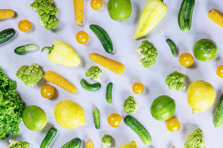 fresh vegetables and fruits on white wooden background