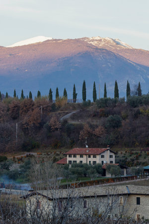 Splendid view of the snow-covered Monte Baldo and the path with cypresses from the Velleselle on the hills of Bardolino.のeditorial素材