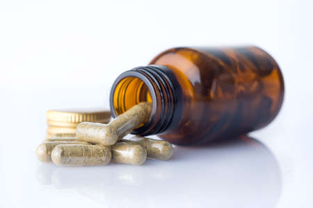 Bottle of homeopatic pills with some pillsの写真素材