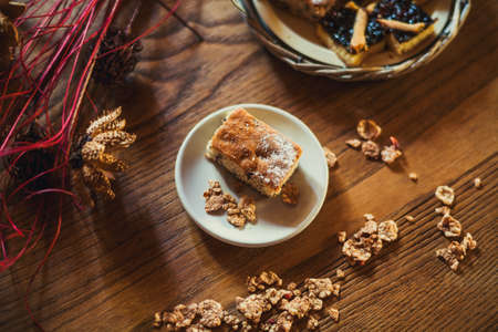 Homemade sweets on a light table background with cereals, purple flowers and notebookの写真素材