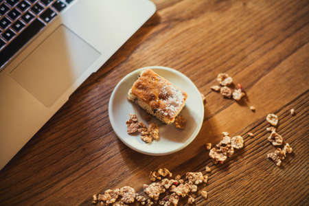 Homemade sweets on a light table background with cereals, purple flowers and notebookの写真素材