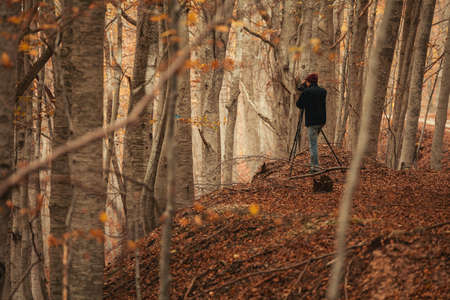 Photographer is shooting some photo to the forest near the road to arrive to the Morricana Fallsの写真素材