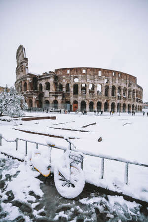 A lovely day of snow in Rome, Italy, 26th February 2018: a view of snowy bikes behind the Colosseumのeditorial素材