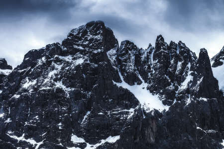 Epic close-up view of some mountain peaks somewhere in Dolomites, Italy. Arounded by clouds. High...