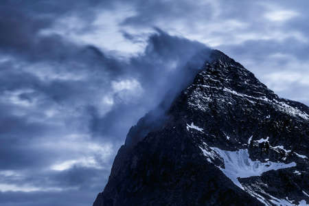 Epic close-up view of some mountain peaks somewhere in Dolomites, Italy. Arounded by clouds. High...