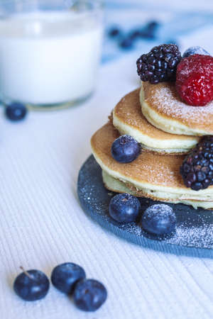 Delicious homemade pancakes with berries and milkの写真素材