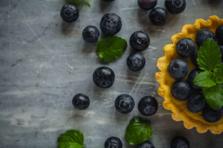 blueberries egg tart on the wooden table.の写真素材