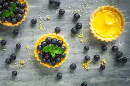 blueberries egg tart on the wooden table.