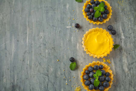 blueberries egg tart on the wooden table.