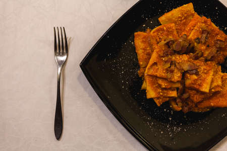 Pasta dish in a rustic restaurantの写真素材