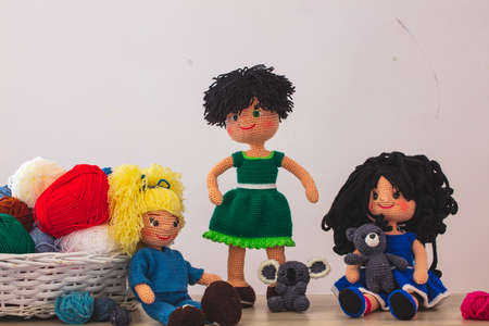Cute wool dolls are lying on the tableの写真素材