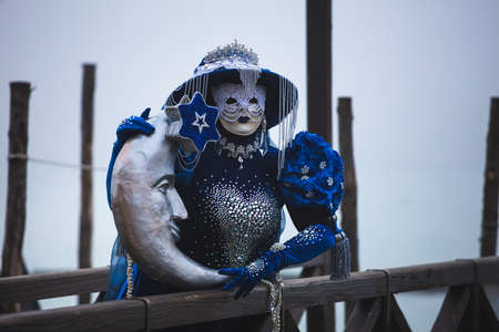 Portrait of a woman with a beautiful blue mask in Venice, Italyの写真素材