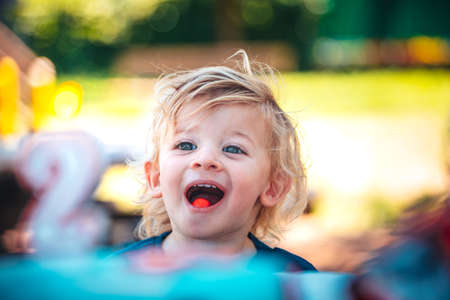 Little funny child celebrates his two yearsの写真素材