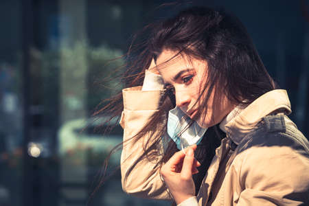Girl with medical mask is staying in the city during pandemic of Coronavirus Covid-19の写真素材