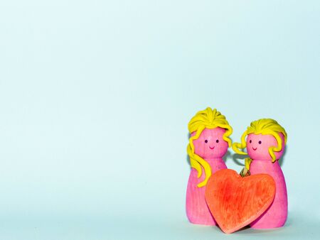 a wooden couple on a customizable background for wedding anniversary or saint valentine dayの写真素材