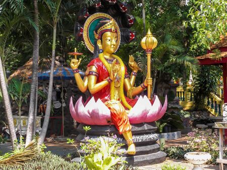 a thai goddess with four hands in a park in thailandの写真素材