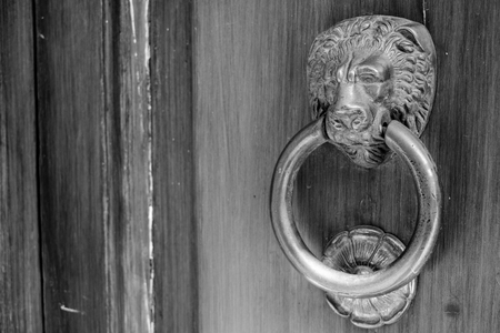 an ancient clapper on an ancient wooden doorの写真素材