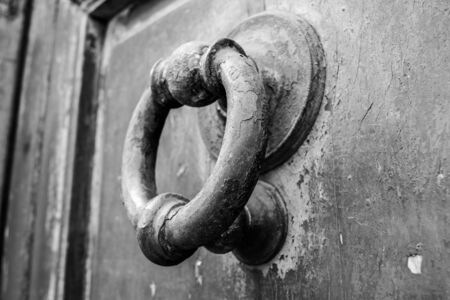 an ancient clapper on an ancient wooden doorの写真素材