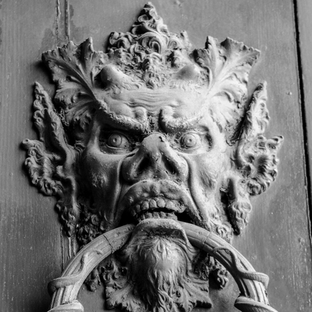 an ancient clapper on an ancient wooden door