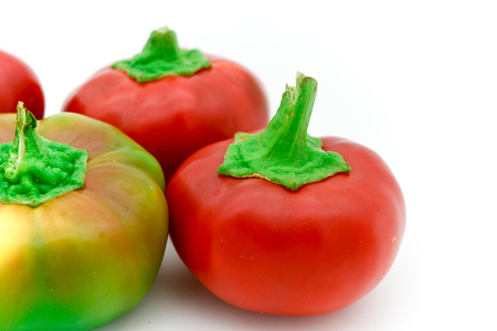 red an yellow little italian sweet peppers isolated in white backgroundの写真素材
