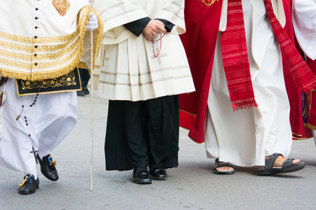 detail of the trditional dresses of christian confraternity members during a processionの写真素材