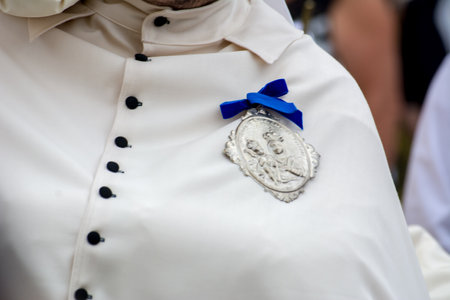 detail of the trditional dress of a christian confraternity member during a processionのeditorial素材