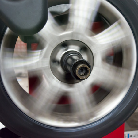 tyre spinning on the balancing machine at the tyre shopの写真素材