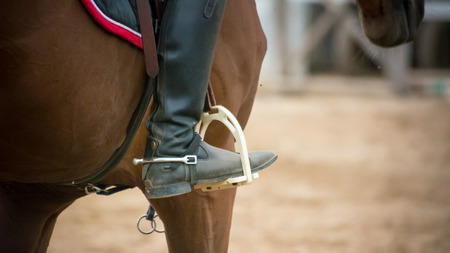 close up of a foot inside the stirrups on blur backgroundの写真素材