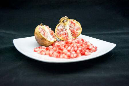 open pomegranade composition on dark backgroundの写真素材