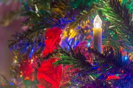 Close Up of Electric Candles as Decoration On the Christmas Tree At Home during the Christmas Period on Soft Backgroundの写真素材