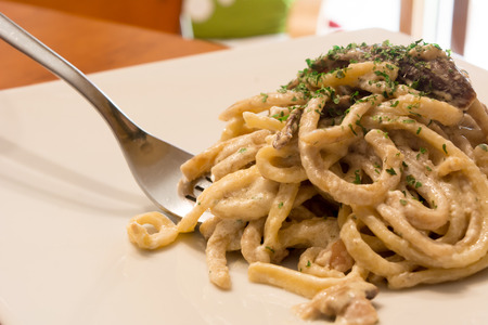 Horizontal View Of Close Up Of A Hot And Smoking Italian Traditional Food Called Pasta Alla Boscaiola Made With Fettuccine, Besciamella And Porcini Mushroomsの写真素材