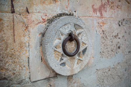 Close Up of a Medieval Steel Ring for Parking Mules Near the Wall on the Street. Matera, South of Italyの写真素材