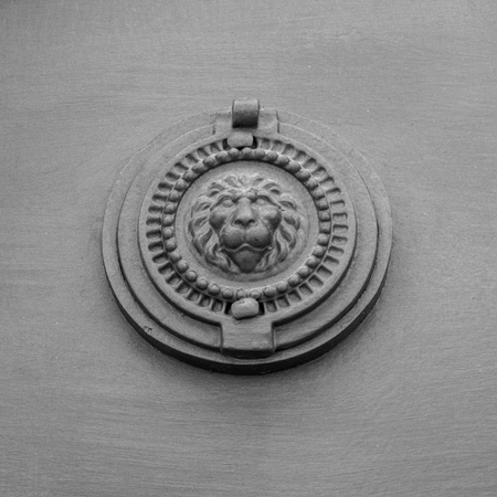 Close Up of an Ancient Peephole Covered By an Old Steel Decorated Cover On a Old Door. Locorotondo, South of Italyの写真素材