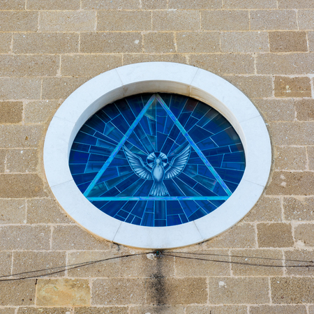 Horizontal View of the Rose Window of the Church of SS Maria Immacolata, Depicting a Triangle With a Dove. Leporano, South of Italyの写真素材