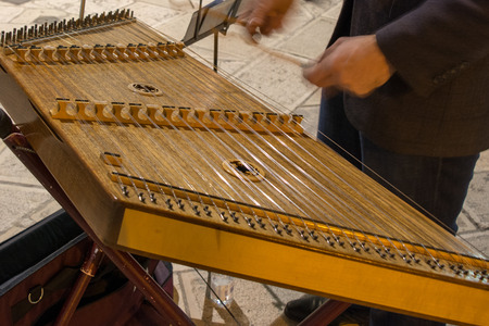 Horizontal View of Close Up of Hands Playing the Salterio Medieval Classical Instrument