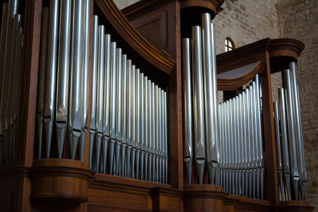 Horizontal View of Close Up of the Pipes of a Pipe Organ in a Churchの写真素材