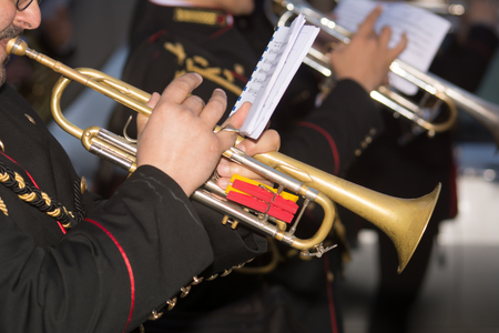 Horizontal View of Close Up of Musician Playing Trumpet in Black Uniformの写真素材